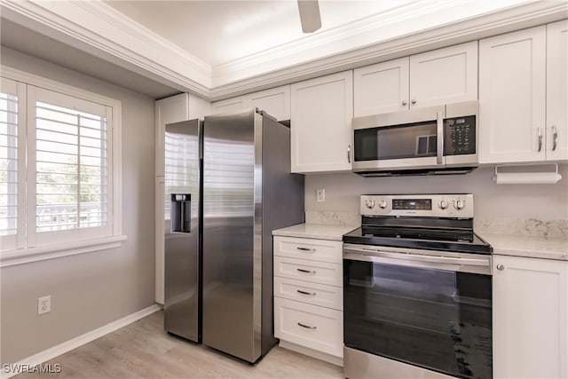 kitchen with white cabinetry, stainless steel appliances, crown molding, light wood finished floors, and light countertops