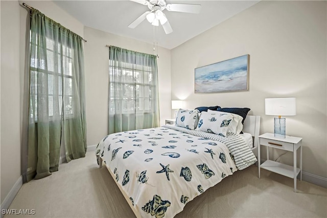 bedroom featuring ceiling fan and carpet