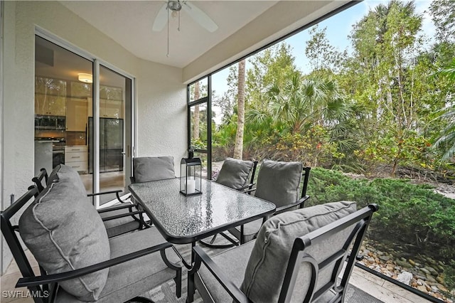 sunroom featuring ceiling fan