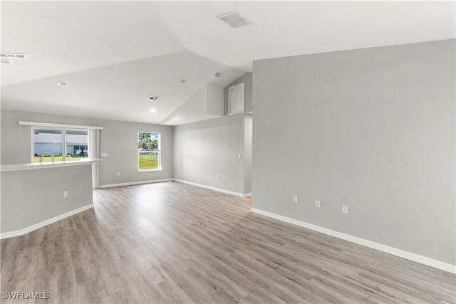 unfurnished living room featuring light hardwood / wood-style flooring and vaulted ceiling