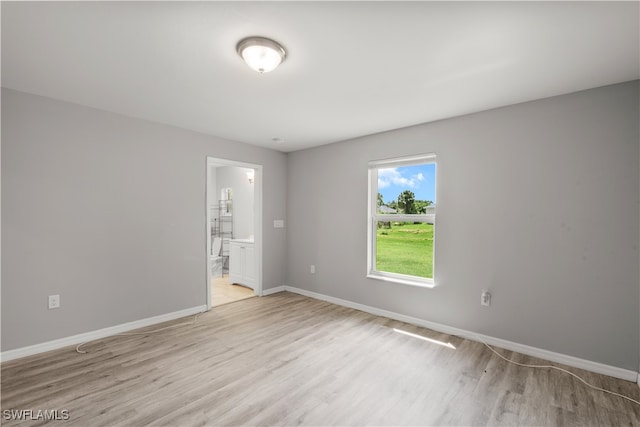 empty room with light hardwood / wood-style flooring