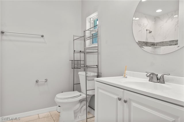 bathroom with tiled shower, vanity, toilet, and tile patterned floors