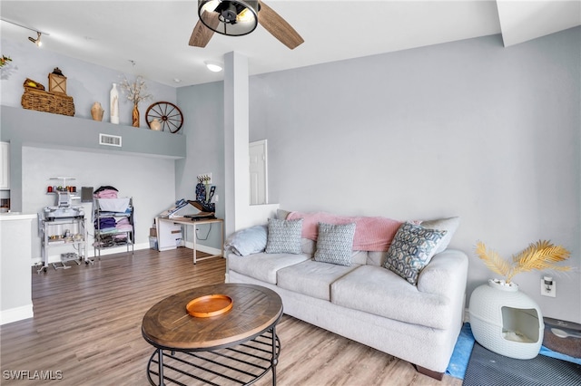 living room with ceiling fan and light hardwood / wood-style flooring