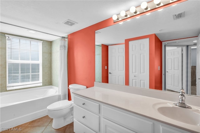 full bathroom with tile patterned flooring, vanity, toilet, and shower / bath combo with shower curtain