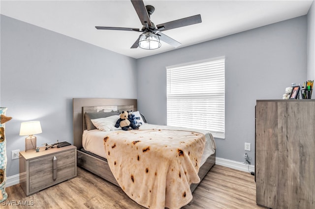 bedroom featuring light hardwood / wood-style floors and ceiling fan