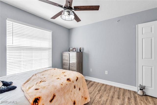 bedroom featuring ceiling fan and wood-type flooring