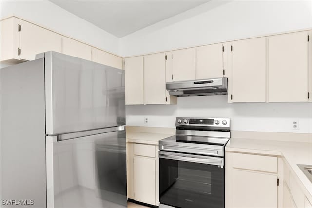 kitchen featuring lofted ceiling and appliances with stainless steel finishes