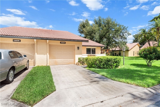 view of front of property with a garage and a front lawn