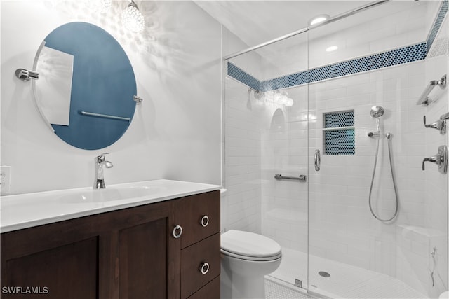 bathroom featuring walk in shower, vanity, and toilet