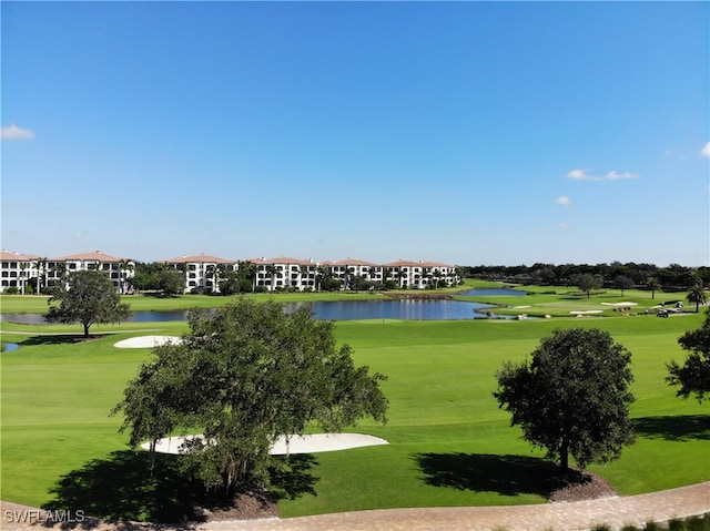 view of home's community featuring a lawn and a water view