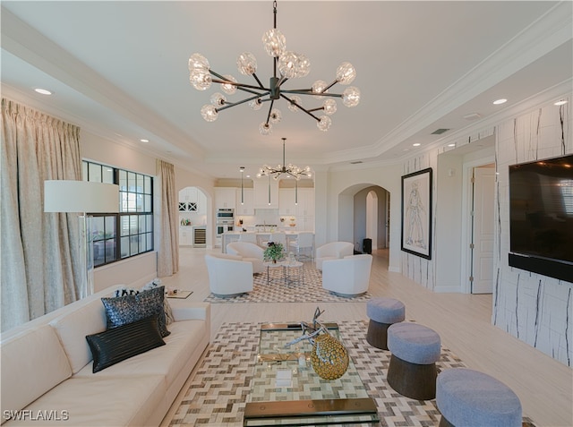 living room featuring crown molding and a chandelier