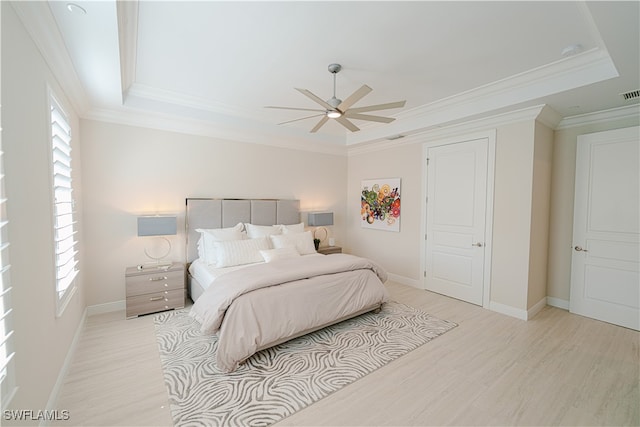 bedroom with ceiling fan, ornamental molding, light hardwood / wood-style flooring, and multiple windows