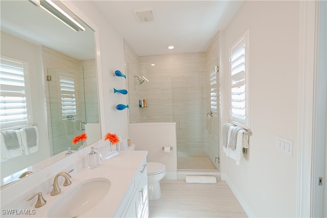 bathroom featuring tile patterned flooring, toilet, an enclosed shower, and vanity