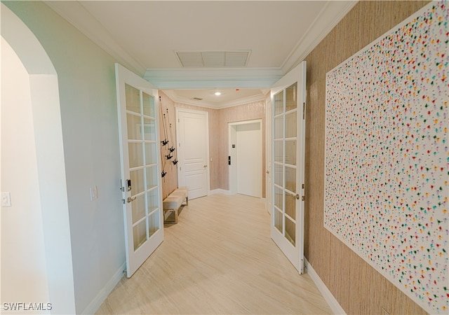 hallway featuring french doors, ornamental molding, and hardwood / wood-style floors