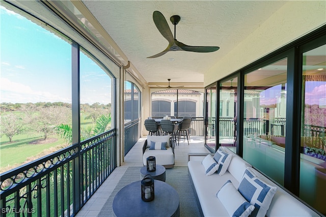 sunroom featuring ceiling fan