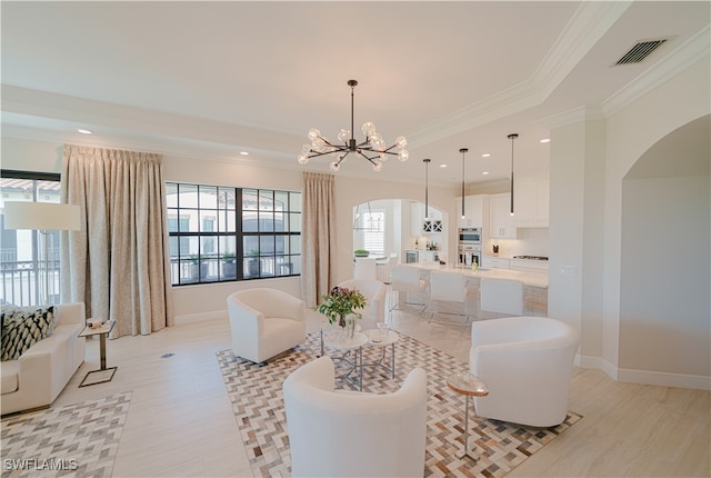 living room featuring ornamental molding and a notable chandelier