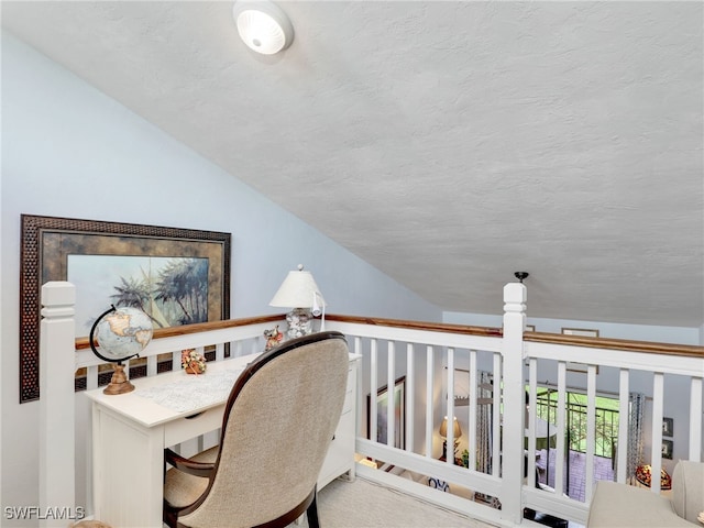 office space with vaulted ceiling and a textured ceiling