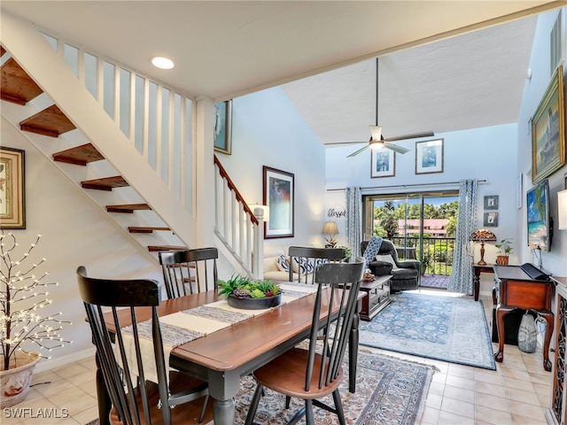 tiled dining area featuring ceiling fan and vaulted ceiling