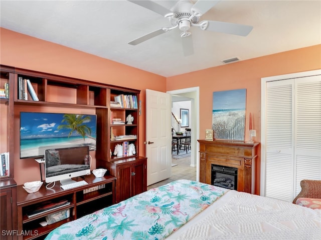 bedroom with ceiling fan and a closet