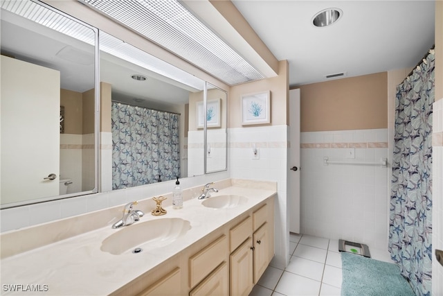 bathroom featuring vanity, tile walls, tile patterned flooring, and curtained shower