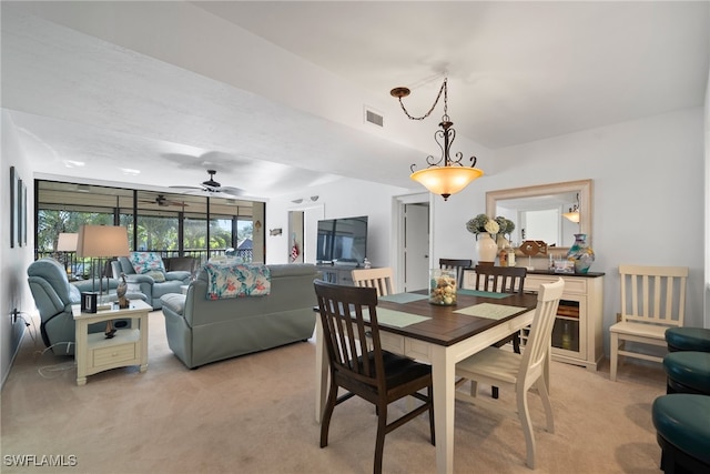 carpeted dining area featuring ceiling fan