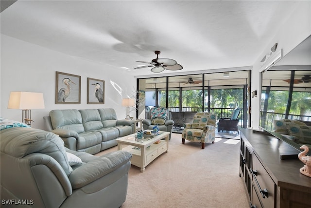 living room with ceiling fan and light colored carpet