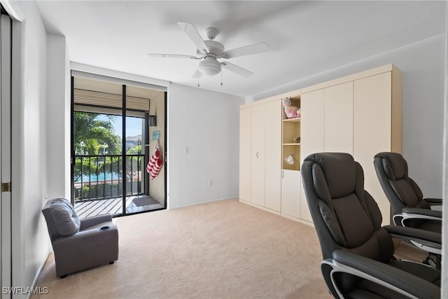 carpeted office featuring ceiling fan