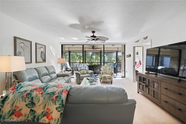 carpeted living room with ceiling fan and a textured ceiling