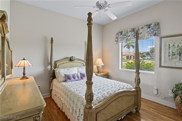 bedroom with ceiling fan and dark hardwood / wood-style flooring