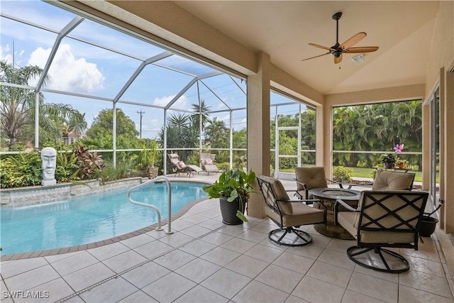 view of pool featuring a lanai, ceiling fan, and a patio area