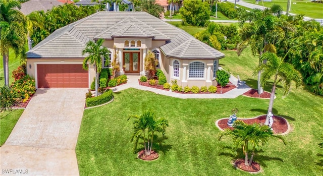 view of front of house with a garage and a front yard