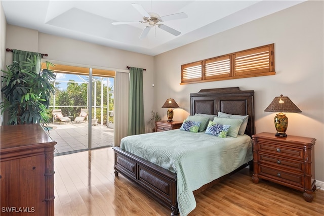 bedroom with access to outside, light wood-type flooring, and ceiling fan