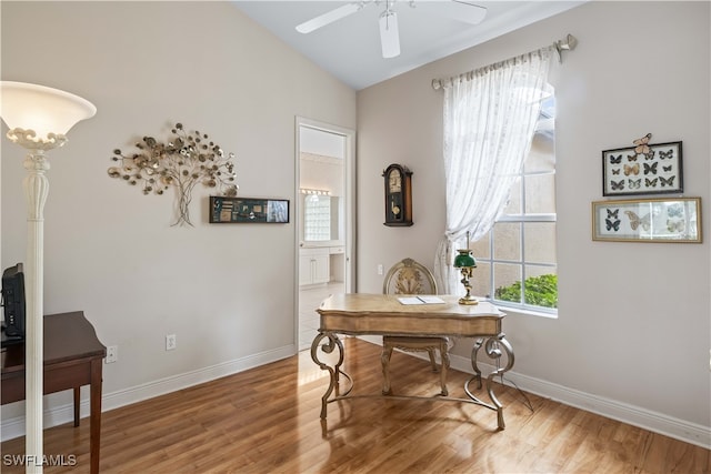 office space featuring ceiling fan, vaulted ceiling, hardwood / wood-style floors, and a healthy amount of sunlight