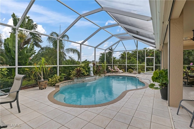 view of pool featuring ceiling fan, glass enclosure, and a patio