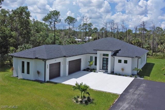 view of front of home featuring a front yard and a garage