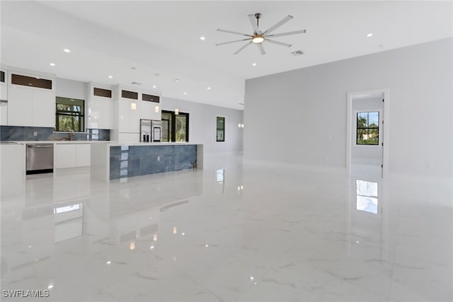 kitchen with white cabinets, ceiling fan, plenty of natural light, and stainless steel appliances