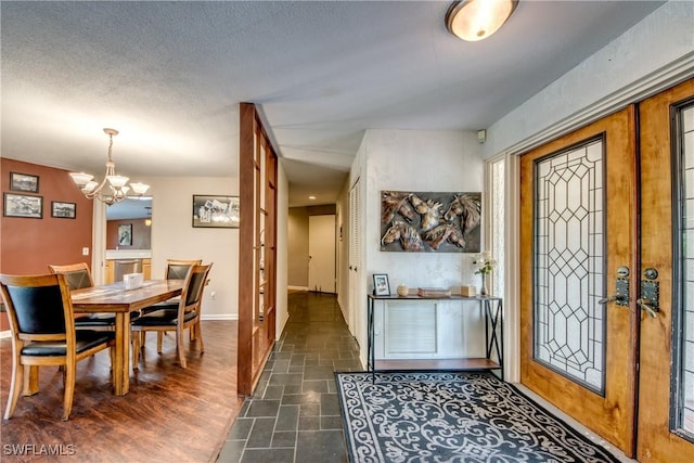 foyer with a chandelier and french doors