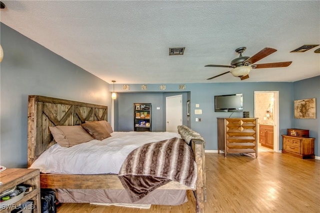 bedroom with connected bathroom, ceiling fan, a textured ceiling, and light wood-type flooring