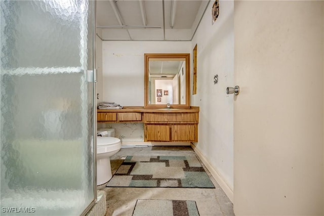 bathroom with vanity, toilet, a shower with door, and concrete floors