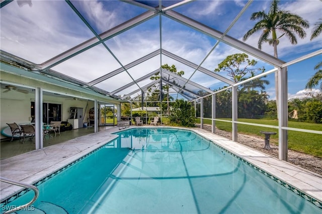 view of pool featuring glass enclosure and a patio area