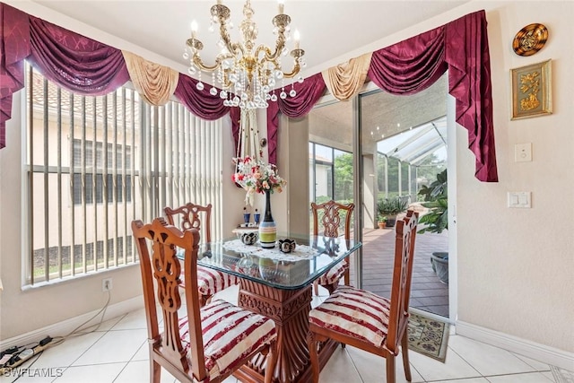 dining area with tile patterned floors, a notable chandelier, and baseboards