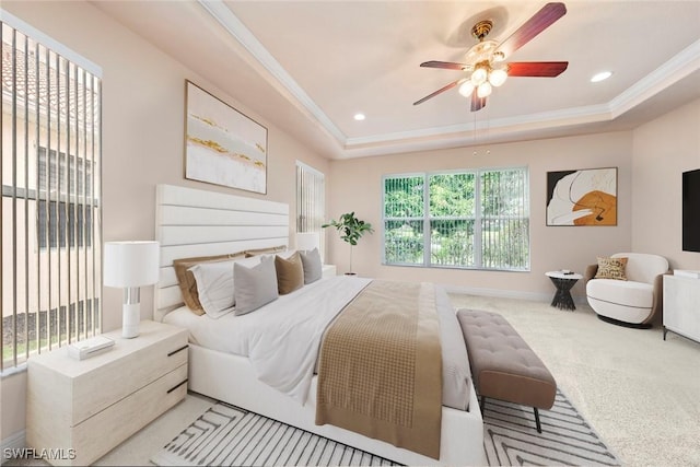 carpeted bedroom featuring ornamental molding, ceiling fan, recessed lighting, and a tray ceiling