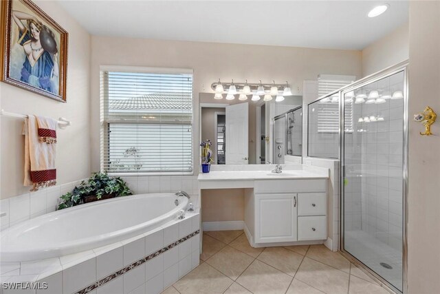 bathroom with a bath, a stall shower, vanity, and tile patterned flooring