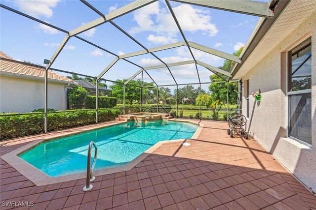 view of swimming pool with a patio area, a pool with connected hot tub, and glass enclosure