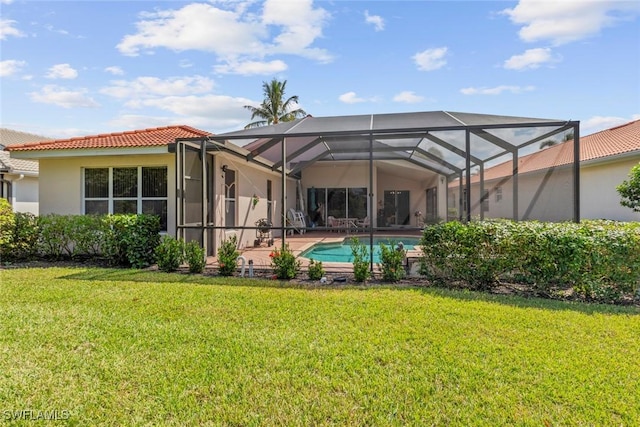 rear view of house with a tiled roof, a lawn, glass enclosure, stucco siding, and an outdoor pool