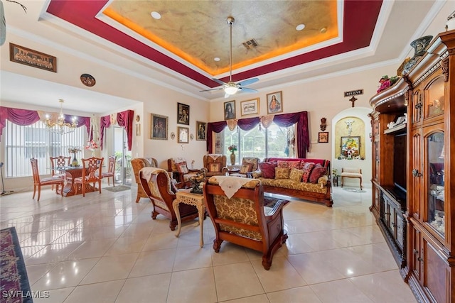 living room with a raised ceiling, light tile patterned floors, ornamental molding, and plenty of natural light