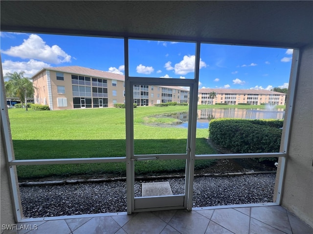 unfurnished sunroom featuring a water view