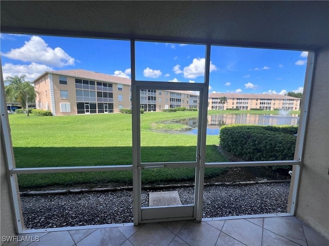 unfurnished sunroom with a water view