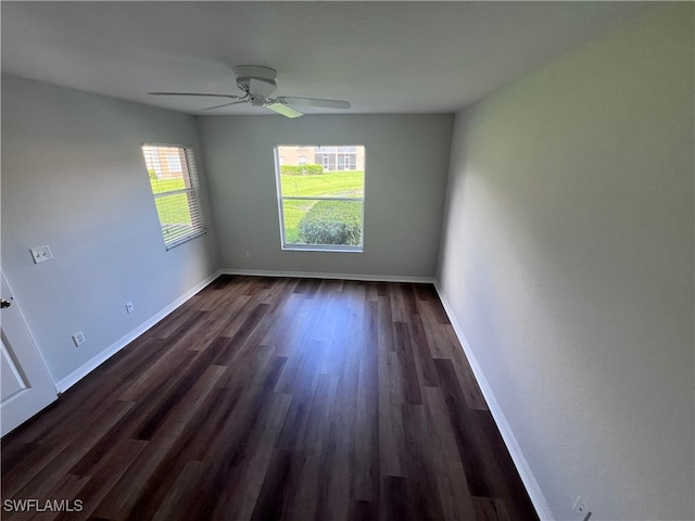 unfurnished room featuring ceiling fan and dark wood-type flooring