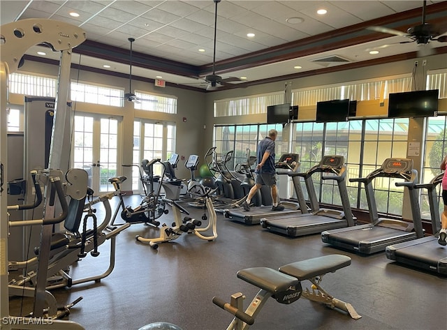 exercise room with ceiling fan, ornamental molding, and a paneled ceiling